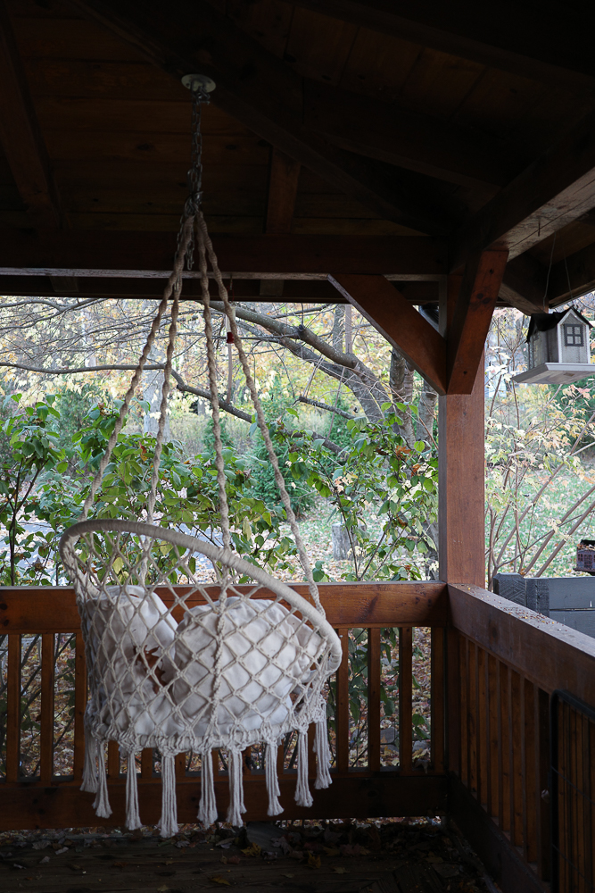A hanging chair on a porch